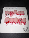 Red and white dotted French press on nails